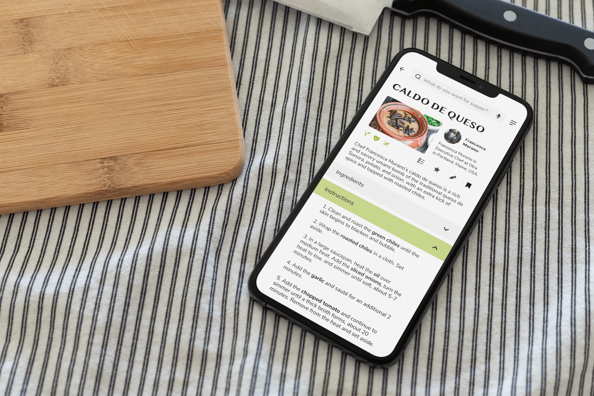 mockup of Supper Club app screen of a recipe near cutting board and knife